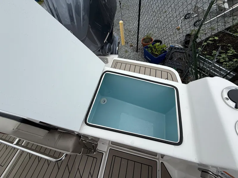 Slide: The Image of Open storage compartment on 2025 Cutwater C-248 Coupe boat deck. - 9