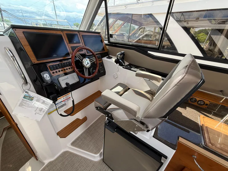 Slide: The Image of 2025 Cutwater C-288 Coupe helm with modern controls and comfortable seating. - 15