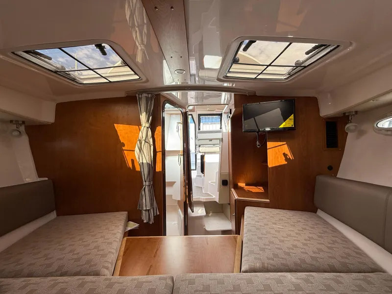 Slide: The Image of Interior of 2025 Cutwater C-288 Coupe, featuring cozy seating and modern amenities. - 22