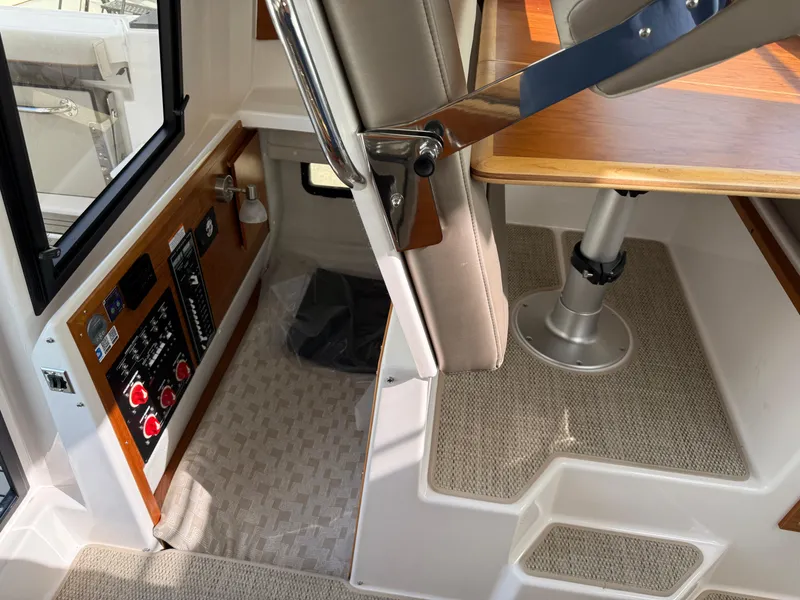 Slide: The Image of Interior of 2025 Cutwater C-288 Coupe, featuring control panel and seating area. - 27