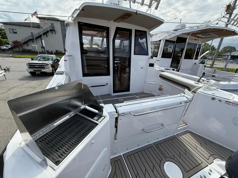 Slide: The Image of 2025 Cutwater C-288 Coupe boat with outdoor grill and sleek deck design. - 28