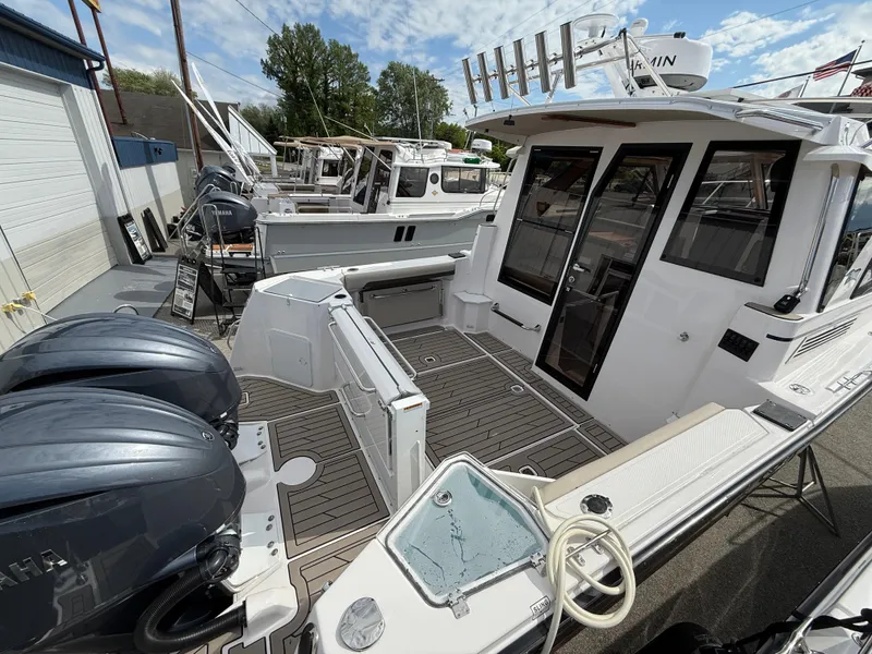 Slide: The Image of 2025 Cutwater C-288 Coupe boat with dual engines, docked outdoors. - 4