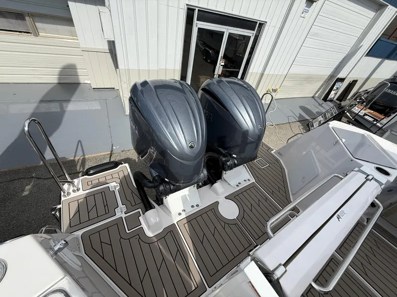 Slide: The Image of 2025 Cutwater C-288 Coupe with dual outboard engines, docked at a marina. - 5
