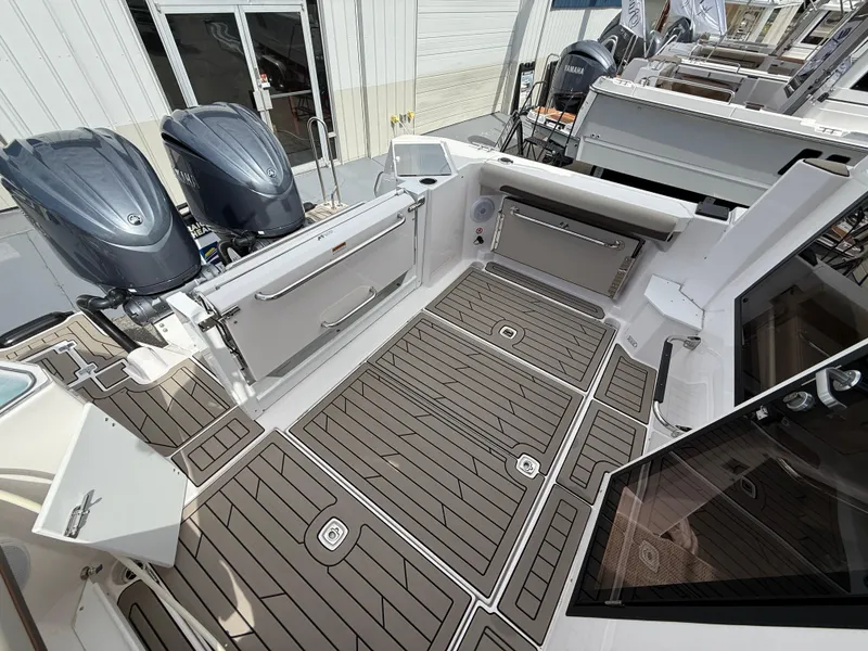 Slide: The Image of 2025 Cutwater C-288 Coupe boat deck with twin outboard motors and sleek design. - 6