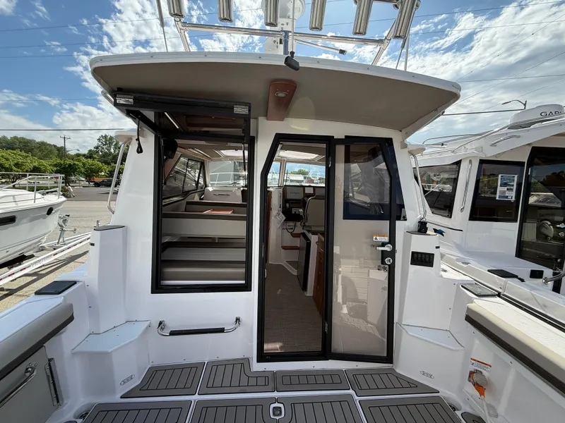 Slide: The Image of 2025 Cutwater C-288 Coupe boat interior with open doors and visible seating area. - 9
