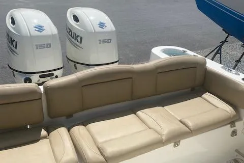 Slide: The Image of 2018 NauticStar 2602 Legacy boat with twin Suzuki 150 outboard engines and beige seating. - 12