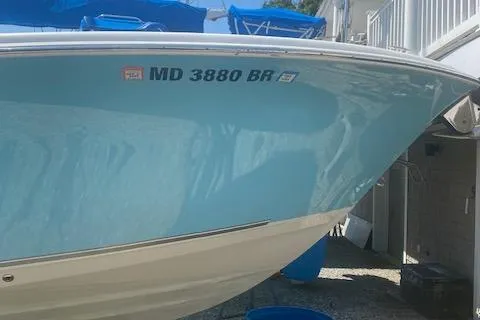 Slide: The Image of 2018 NauticStar 2602 Legacy boat with registration MD 3880 BR, docked outdoors. - 2