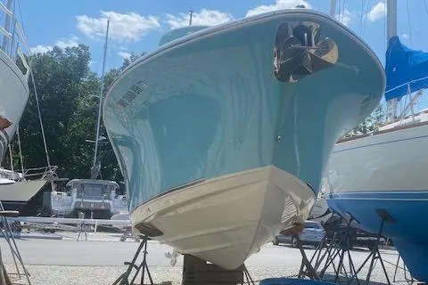 Slide: The Image of 2018 NauticStar 2602 Legacy boat on stands, displayed outdoors under a clear sky. - 4