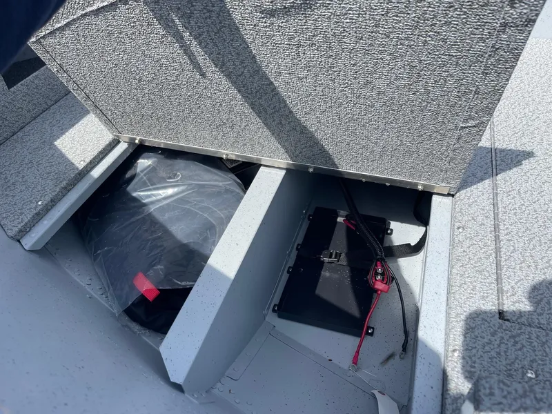 Slide: The Image of 2025 Lund 1600 Fury SS boat storage compartment with battery and equipment. - 7