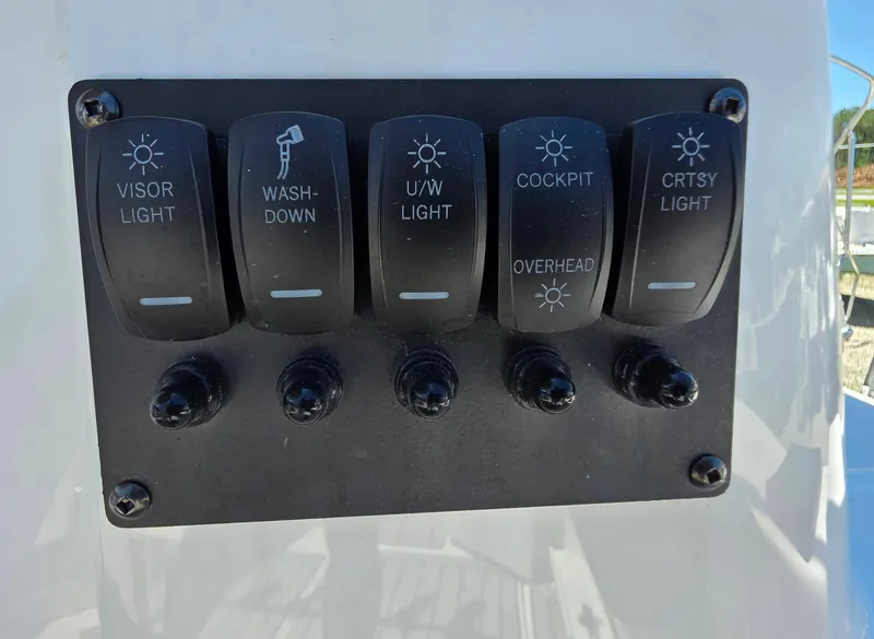 Slide: The Image of Control panel with switches for lights and washdown on 2025 Cutwater C-288 Coupe. - 12