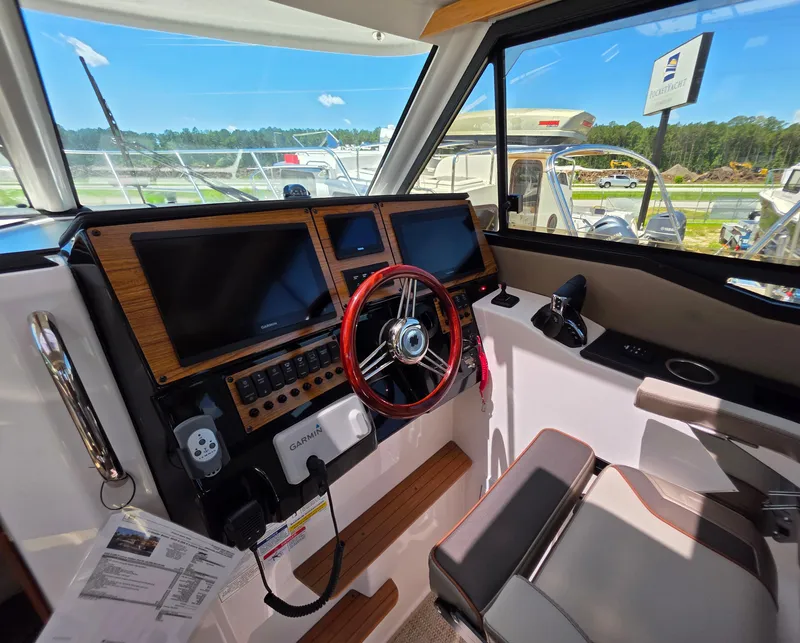 Slide: The Image of 2025 Cutwater C-288 Coupe helm with modern controls and navigation screens. - 8
