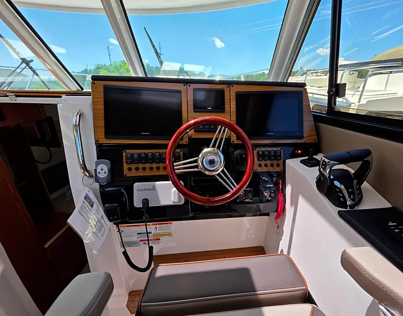 Slide: The Image of Helm of 2025 Cutwater C-288 Coupe with modern navigation displays and controls. - 9