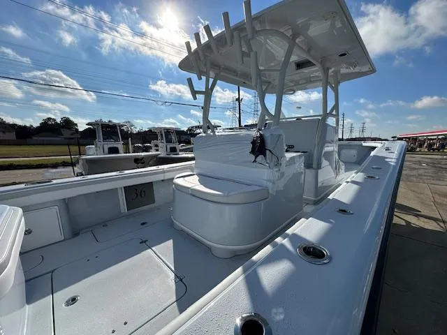 Slide: The Image of 2024 Yellowfin 36 Offshore boat, spacious deck, rod holders, clear sky, and modern design. - 10