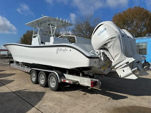 Slide: The Image of 2024 Yellowfin 36 Offshore boat on trailer with Yamaha engines, parked outdoors. - 4