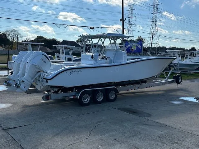 Slide: The Image of 2024 Yellowfin 36 Offshore boat on trailer, parked outdoors under a clear sky. - 9
