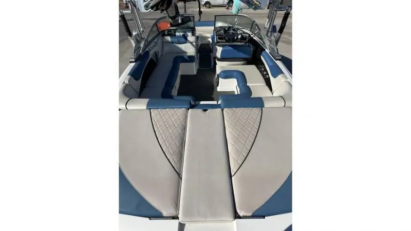 Slide: The Image of 2012 MasterCraft X45 boat interior with blue and gray seating, spacious layout. - 6