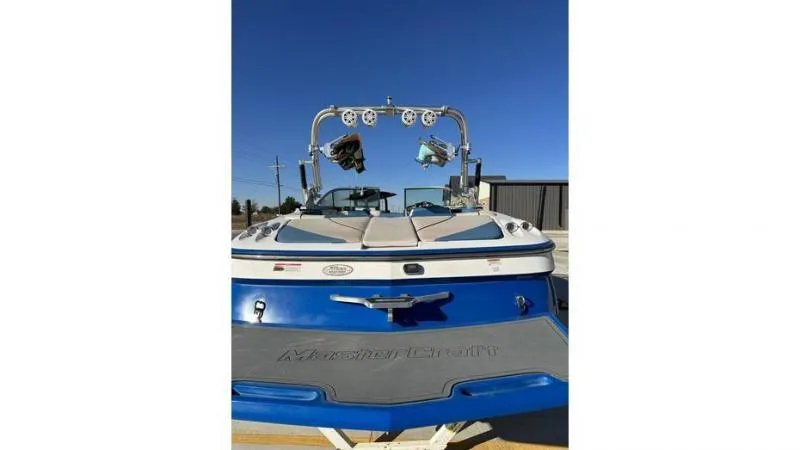 Slide: The Image of 2012 MasterCraft X45 boat, blue and white, rear view with wakeboard tower. - 7