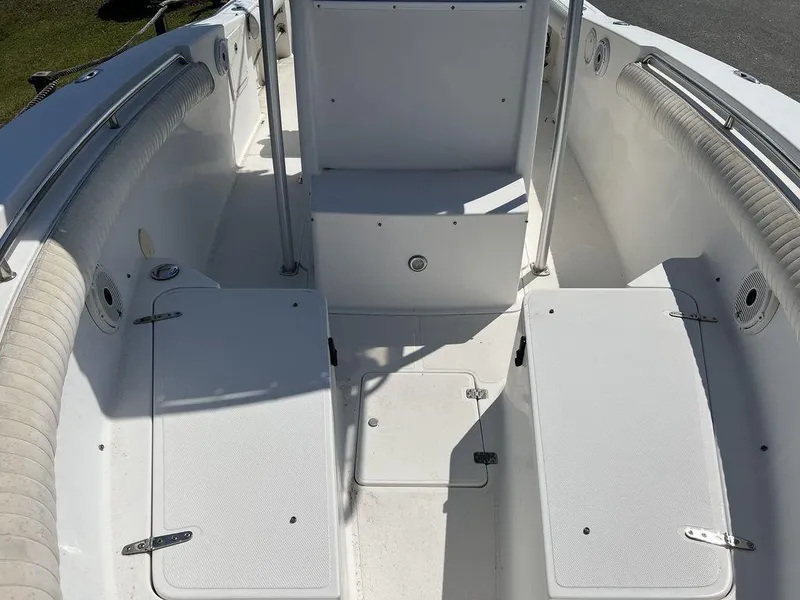 Slide: The Image of 2006 Sea Hunt Triton 260 boat interior with white seating and storage compartments. - 11