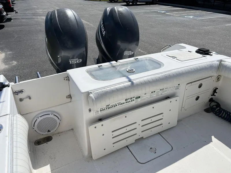 Slide: The Image of 2006 Sea Hunt Triton 260 boat with dual Yamaha 150 engines, featuring a spacious deck layout. - 13