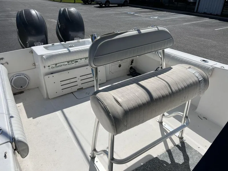 Slide: The Image of 2006 Sea Hunt Triton 260 boat interior with dual engines and seating. - 14