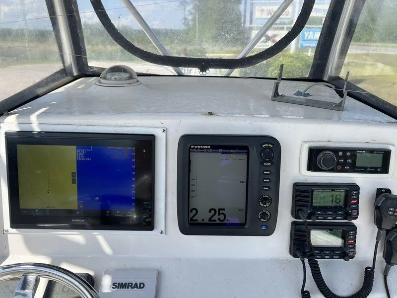 Slide: The Image of Control panel of a 2006 Sea Hunt Triton 260 boat with navigation and communication equipment. - 17