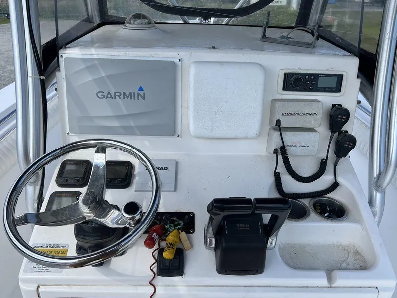 Slide: The Image of 2006 Sea Hunt Triton 260 boat dashboard with Garmin navigation and communication equipment. - 21