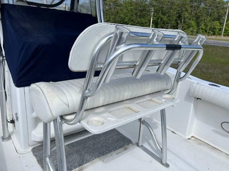 Slide: The Image of 2006 Sea Hunt Triton 260 boat seating with rod holders and cup holders. - 23
