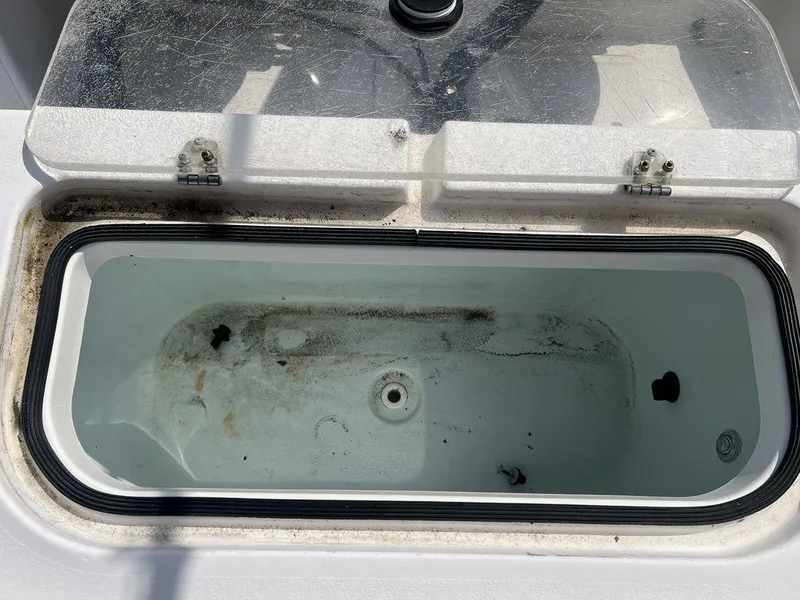 Slide: The Image of Livewell compartment on a 2006 Sea Hunt Triton 260 boat, open lid, showing interior. - 24
