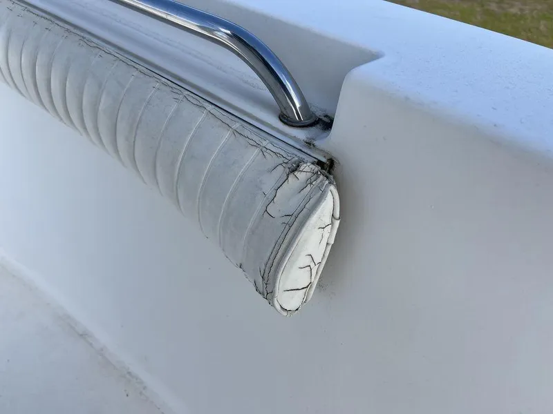 Slide: The Image of Worn upholstery on 2006 Sea Hunt Triton 260 boat with metal railing. - 31