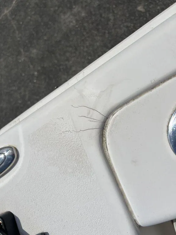 Slide: The Image of Close-up of a 2006 Sea Hunt Triton 260 boat surface with visible cracks. - 33