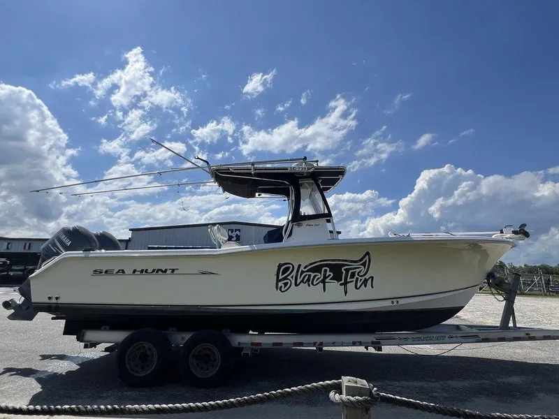 Slide: The Image of 2006 Sea Hunt Triton 260 boat on trailer under blue sky. - 4