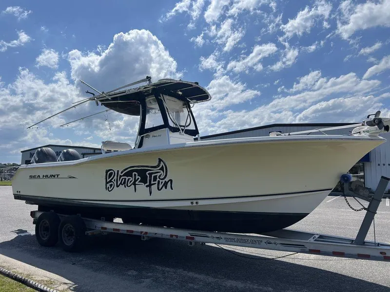 Slide: The Image of 2006 Sea Hunt Triton 260 boat on trailer under blue sky. - 5