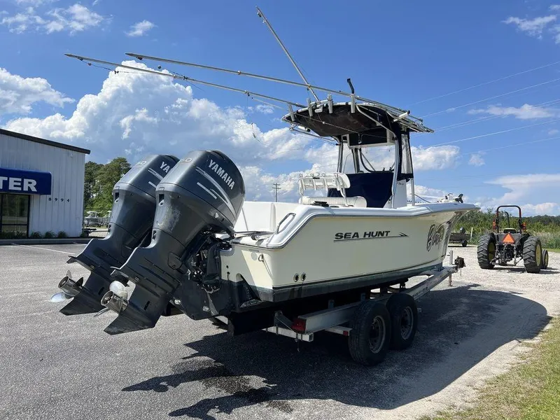 Slide: The Image of 2006 Sea Hunt Triton 260 boat with dual Yamaha engines on a trailer. - 6