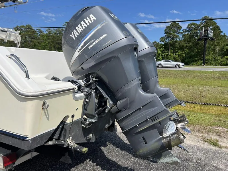 Slide: The Image of 2006 Sea Hunt Triton 260 with Yamaha outboard engines, parked on roadside. - 9
