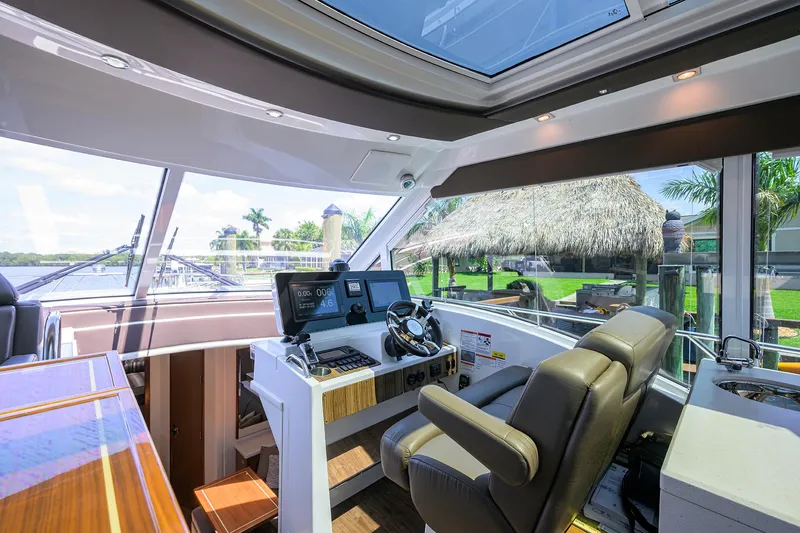 Slide: The Image of 2015 Cruisers Cantius yacht helm with modern controls and panoramic windows. - 13