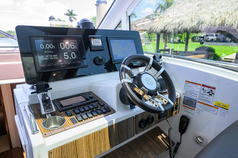 Slide: The Image of 2015 Cruisers Cantius helm with modern controls and navigation screens. - 14