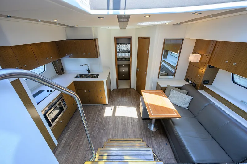 Slide: The Image of Interior of 2015 Cruisers Cantius yacht with modern kitchen and seating area. - 16
