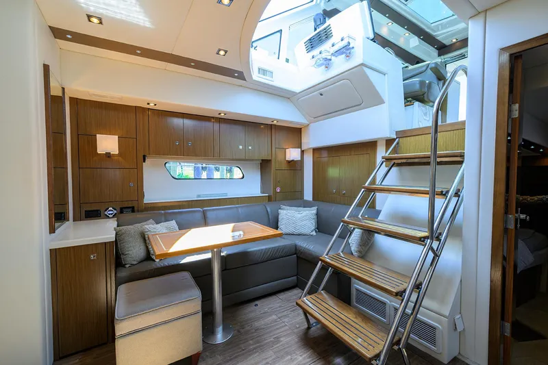 Slide: The Image of Luxurious 2015 Cruisers Cantius yacht interior with modern seating and wooden accents. - 17