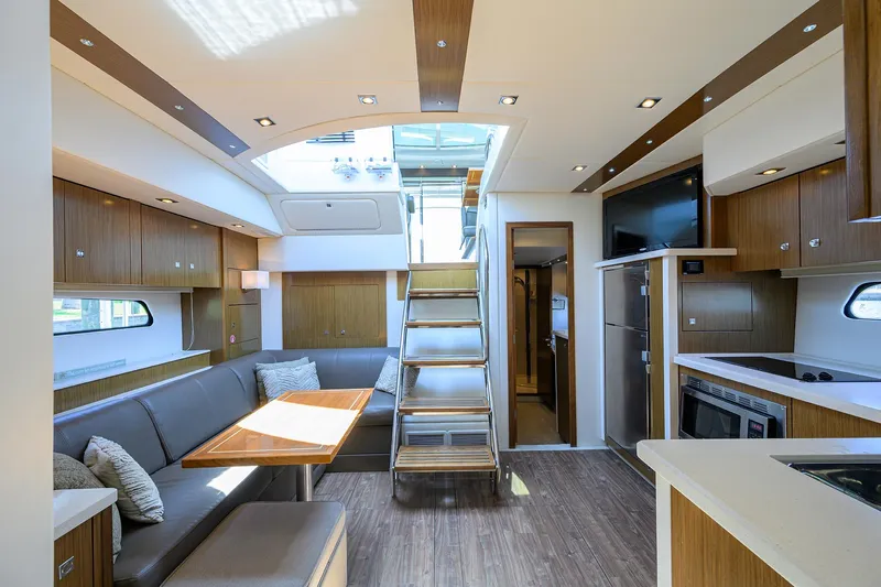 Slide: The Image of Luxurious interior of 2015 Cruisers Cantius yacht with modern kitchen and dining area. - 18