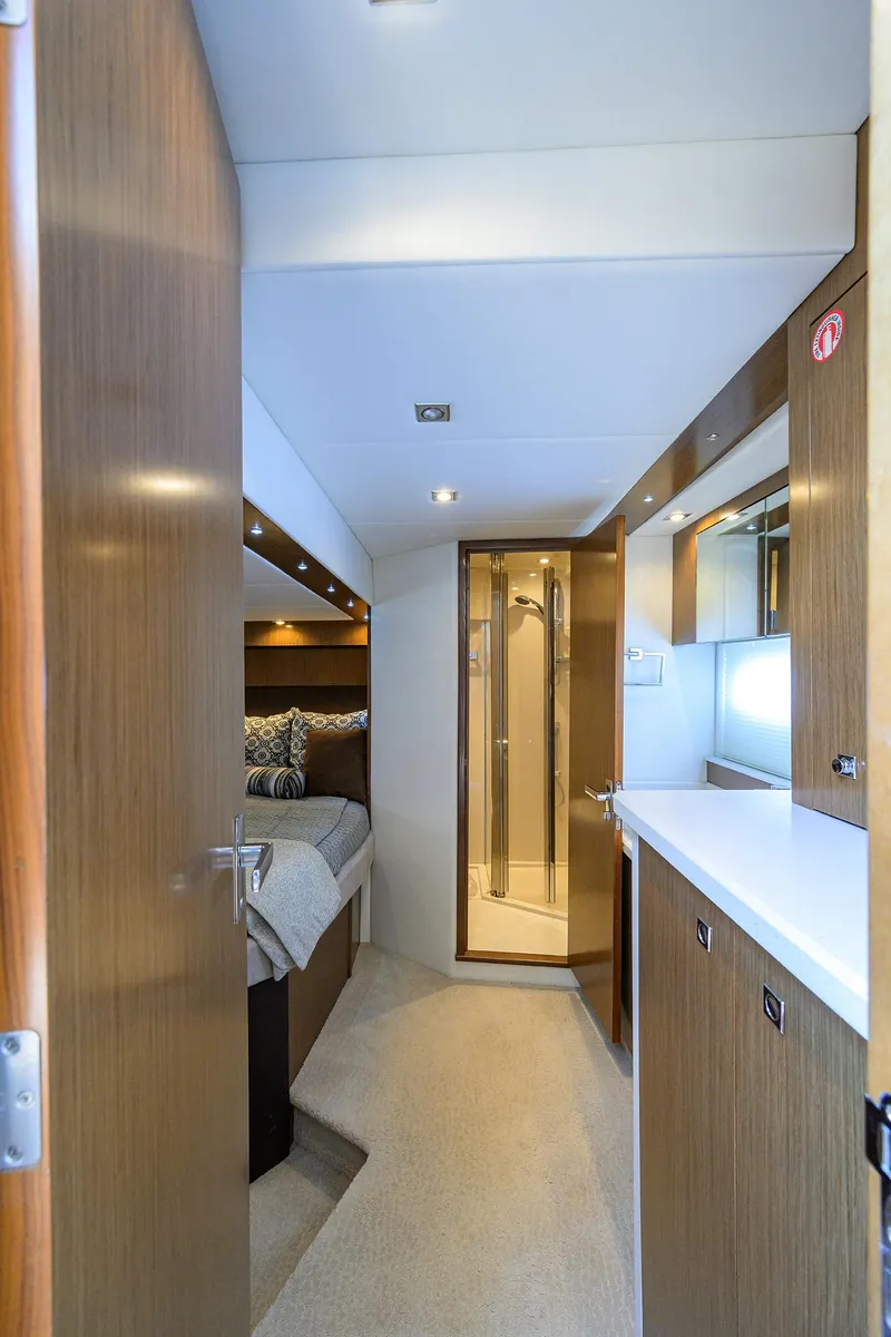 Slide: The Image of 2015 Cruisers Cantius yacht interior with modern wood finish and cozy sleeping area. - 21