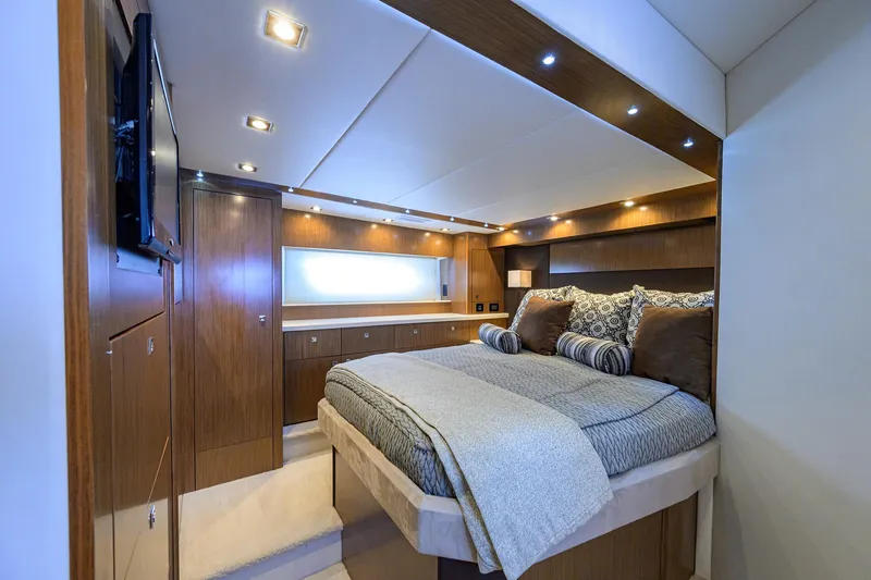 Slide: The Image of Luxurious 2015 Cruisers Cantius yacht bedroom with elegant wood finishes and modern lighting. - 22