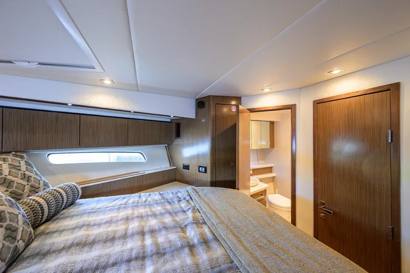 Slide: The Image of Luxurious 2015 Cruisers Cantius yacht bedroom with ensuite bathroom and modern decor. - 28