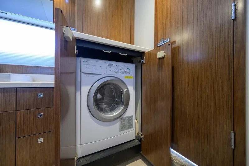 Slide: The Image of 2015 Cruisers Cantius yacht interior with built-in washing machine in wooden cabinet. - 31