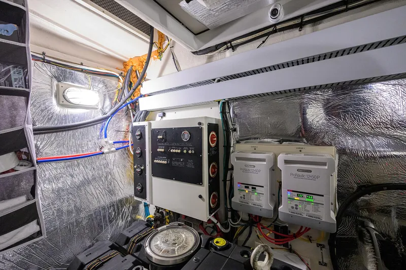 Slide: The Image of Engine room of 2015 Cruisers Cantius yacht with control panels and wiring. - 34