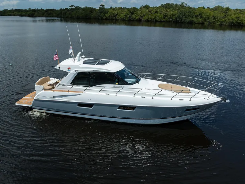 Slide: The Image of 2015 Cruisers Cantius yacht cruising on calm water, surrounded by lush greenery. - 47