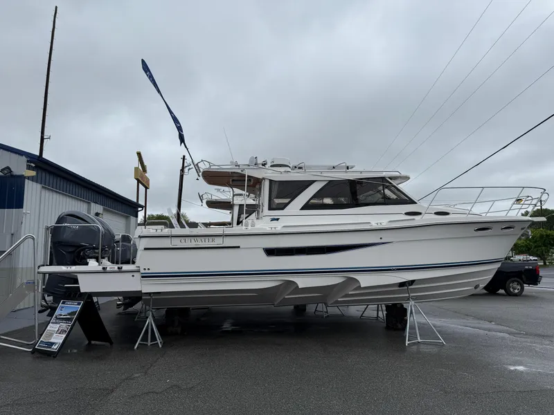 Slide: The Image of 2025 Cutwater C-32 C boat displayed outdoors on a cloudy day. - 1