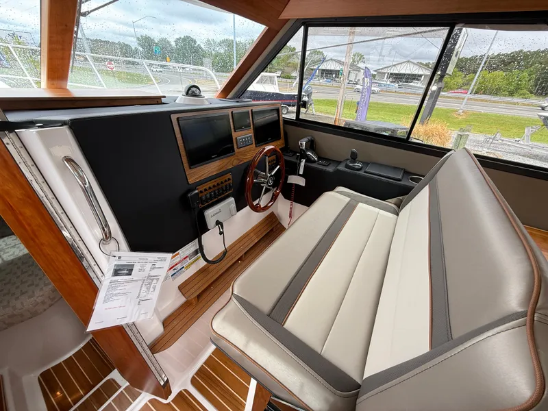 Slide: The Image of 2025 Cutwater C-32 C boat interior with modern helm, dual screens, and comfortable seating. - 16