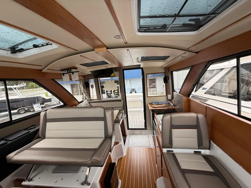 Slide: The Image of Interior of 2025 Cutwater C-32 C boat with modern seating and wood accents. - 20