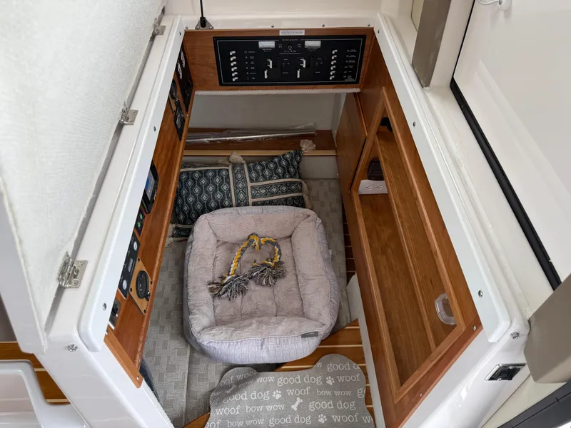 Slide: The Image of 2025 Cutwater C-32 C interior with cozy pet bed and control panel. - 23