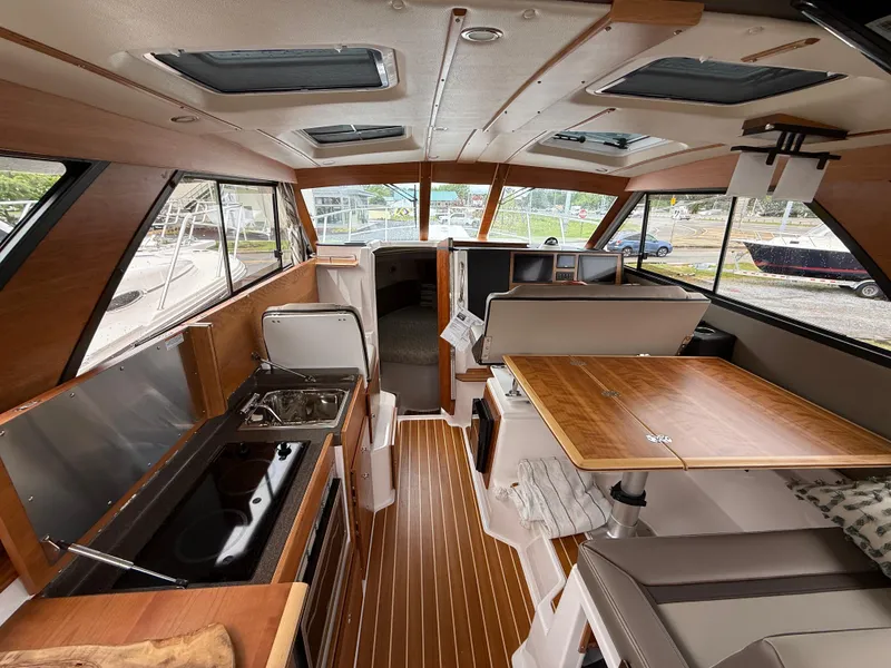 Slide: The Image of Interior of 2025 Cutwater C-32 C boat with modern kitchen and seating area. - 24